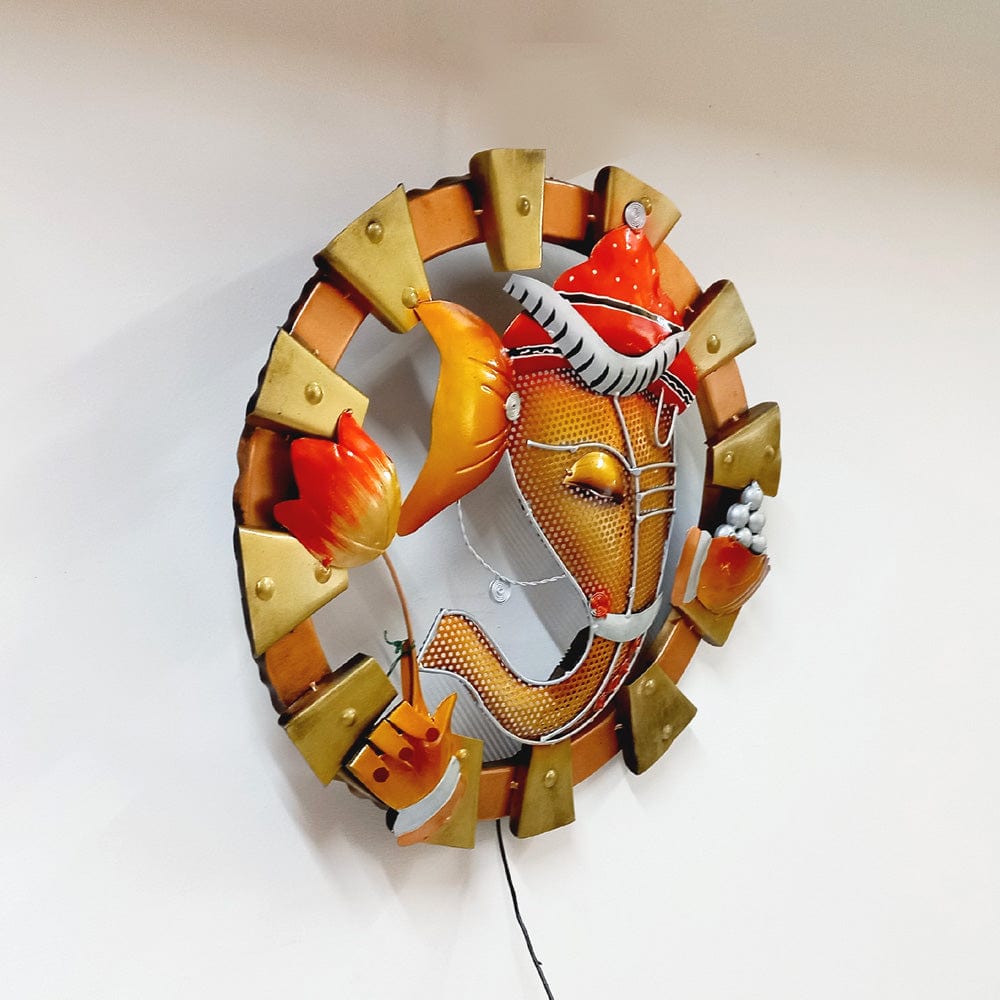 Decorative metal Ganesh wall frame with LED lighting, enhancing beauty and spirituality in any space.