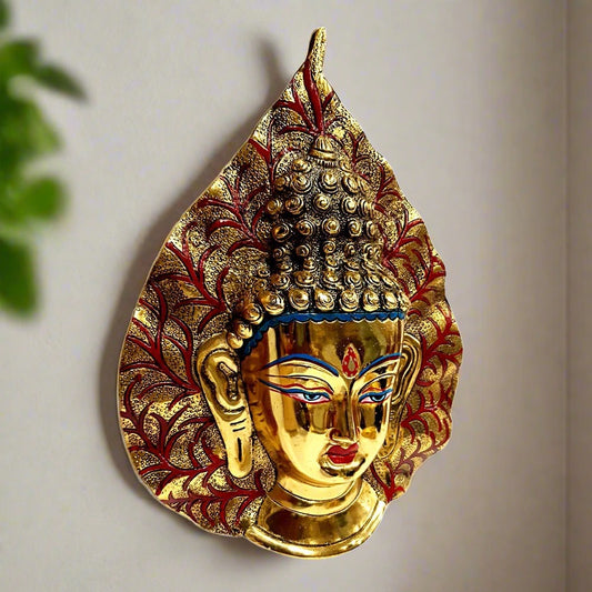Decorative metal Buddha piece with leaf motif and golden oxidize finish for elegant wall decor.