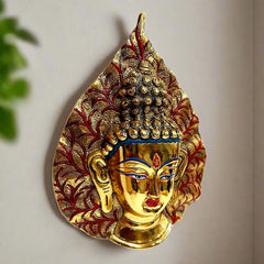 Decorative metal Buddha piece with leaf motif and golden oxidize finish for elegant wall decor.
