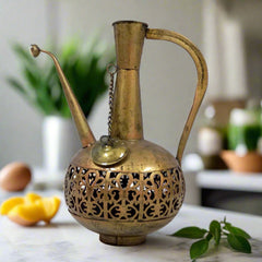 Decorative metal candle stand in the shape of a surahi jug, featuring gold oxidized finish and intricate lattice patterns.