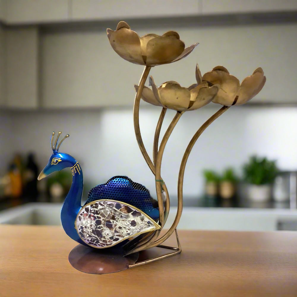 Decorative metal peacock candle holder showpiece with vibrant hand painting and glass-embellished feathers, holding four lotus candle stands.