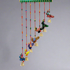 Slant design peacock toran made from paper mache, featuring beads, thread, and decorative stick.