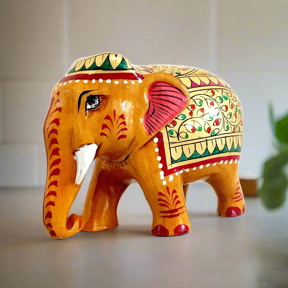 Decorative wooden elephant with vibrant red and green floral painting on gold color, great for home decor and gifting
