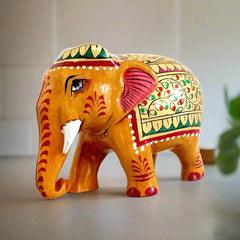 Decorative wooden elephant with vibrant red and green floral painting on gold color, great for home decor and gifting