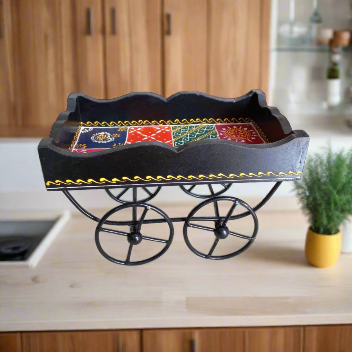 Decorative wooden tray designed as a cart with wheels, showcasing vibrant hand-painted motifs.
