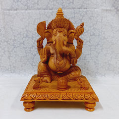 Elegant wooden Ganesh ji idol on decorative chowki, made of kadam wood with intricate hand craftsmanship for home worship.