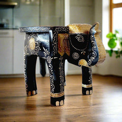 A wooden elephant stool with a plain back and beautiful emboss painting on its body.