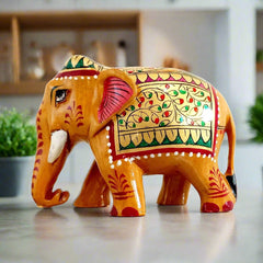 Floral wood elephant art piece hand-painted with red, green, and gold, perfect for home decoration and presents