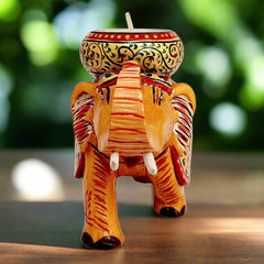 Folk art style wooden elephant candle holder featuring bright hand-painted details and a functional round candle stand.