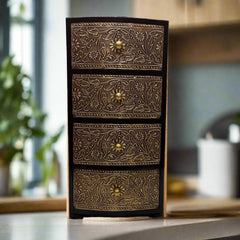 Wooden jewelry box with four drawers in antique finish and decorative metal sheet featuring flower and leaf patterns.