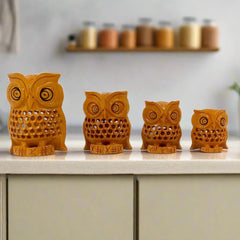 Set of four wooden owl statues in varying sizes with intricate hand-carved mesh design, made from kadam wood.