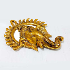 A metal Ganpati wall hanging with a long-lasting golden polish.