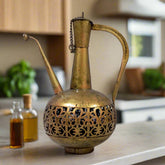 Metal surahi candle holder with gold oxidized painting and bottom candle stand, casting light through lattice design.