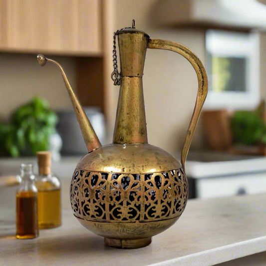 Metal surahi candle holder with gold oxidized painting and bottom candle stand, casting light through lattice design.