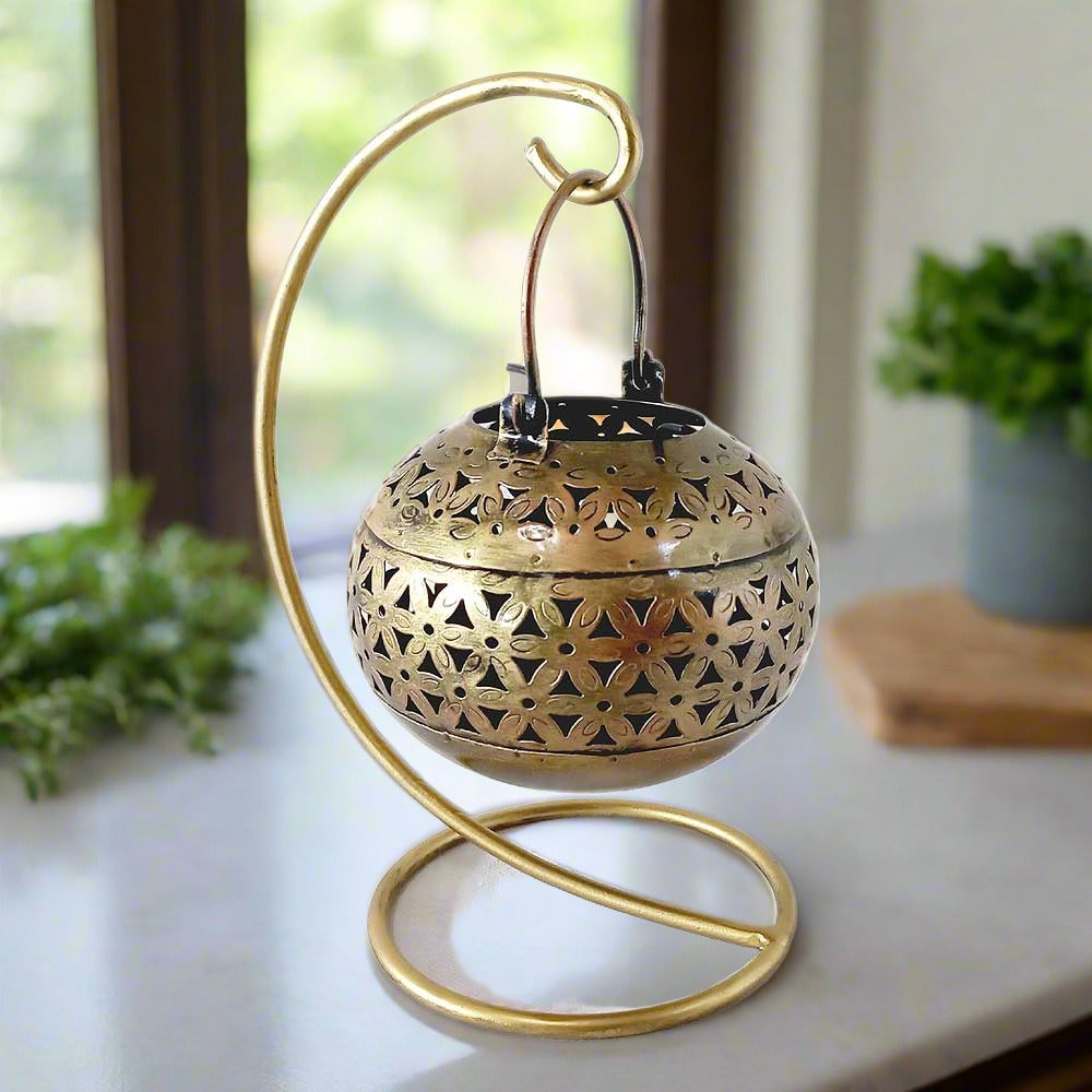A round mesh tealight holder with a stand for both hanging and tabletop use.