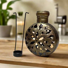 A golden oxidized metal candle stand that can also be used as a decorative showpiece.