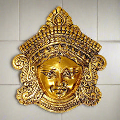 A beautiful golden oxidized metal Maa Durga face wall hanging, perfect for home decor.