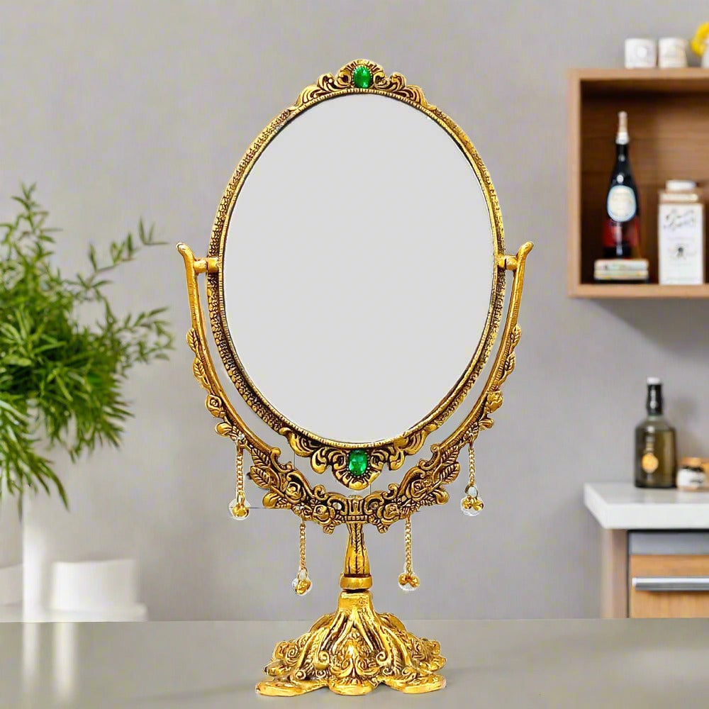 A gorgeous two-way makeup mirror with a royal design, made of metal with a golden oxidized polish.
