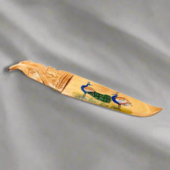 A good quality wooden desk accessory that serves as a paper cutter.