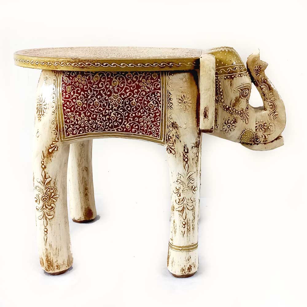 A gorgeous wooden elephant stool with fine carving on the trunk, forehead, and body.