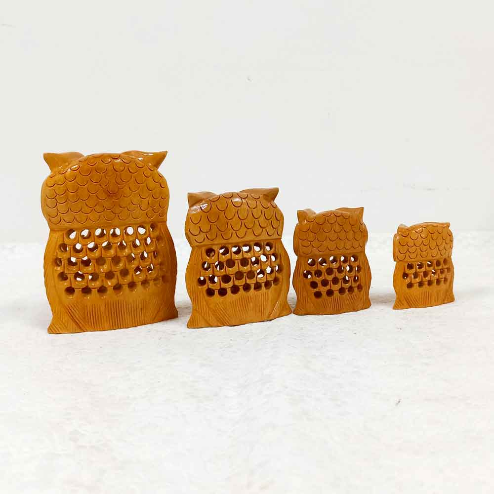 Four-piece hand-carved wooden owl set with detailed mesh patterns and smooth finish, perfect for gifting.
