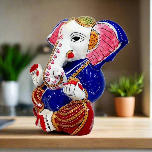 Hand-painted metal Ganesha idol featuring big ears, carrying laddoos, ideal for interior decoration and gifts