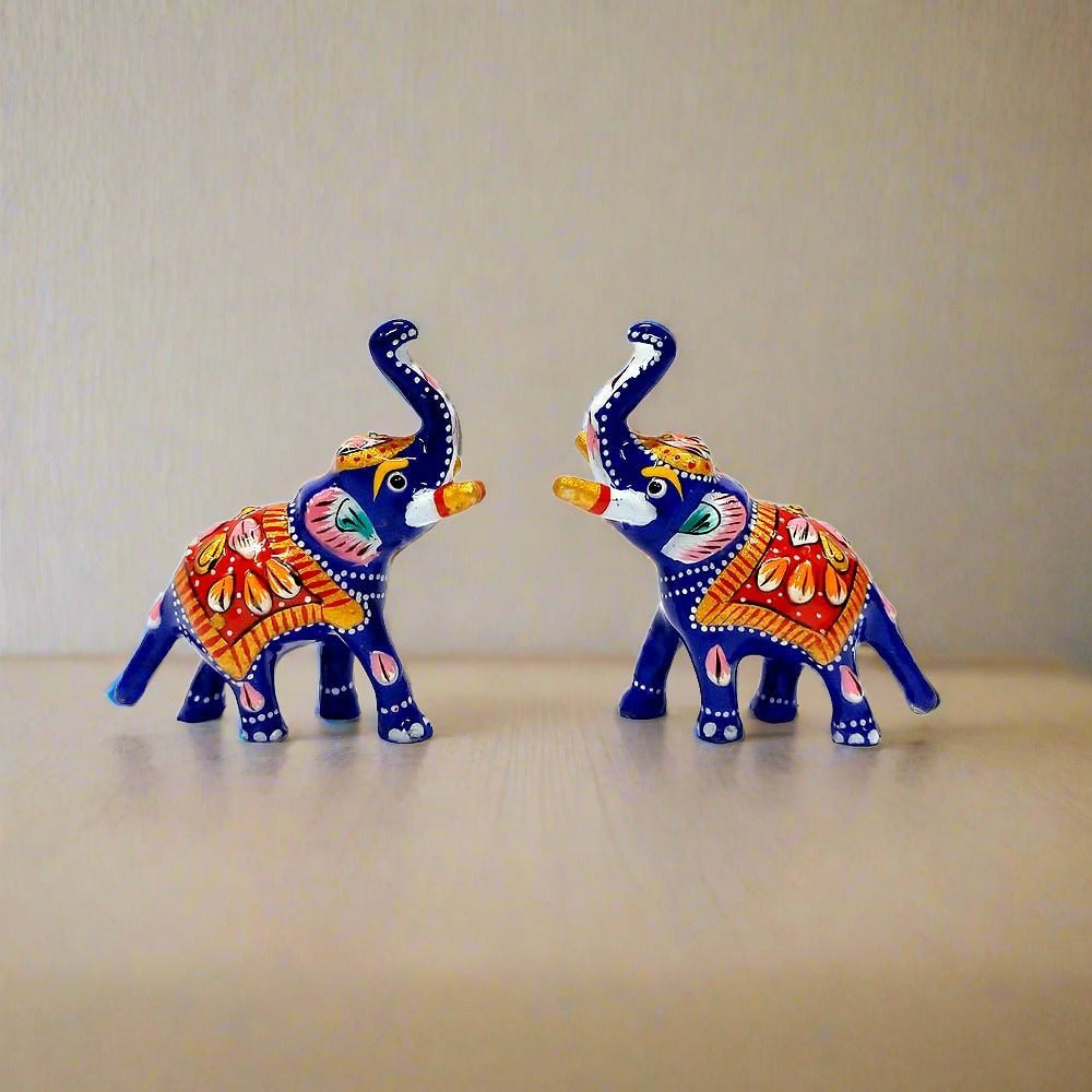 Hand-painted metal toys of elephants, cows, parrots, and peacocks for a home temple.
