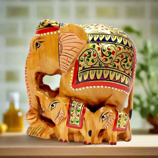 A beautiful hand-painted wooden elephant family statue, perfect for home decoration.