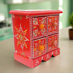 A beautiful hand-painted wooden jewelry box with 4 drawers and vibrant colors.