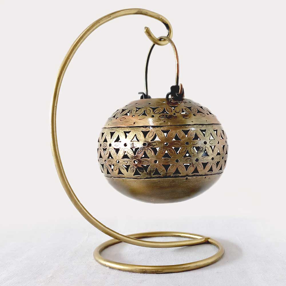 A handcrafted golden mesh pot that serves as a beautiful decorative lighting piece.