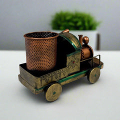 Handcrafted metal train pen holder with antique finish and intricate handmade painting, a stylish office accessory.