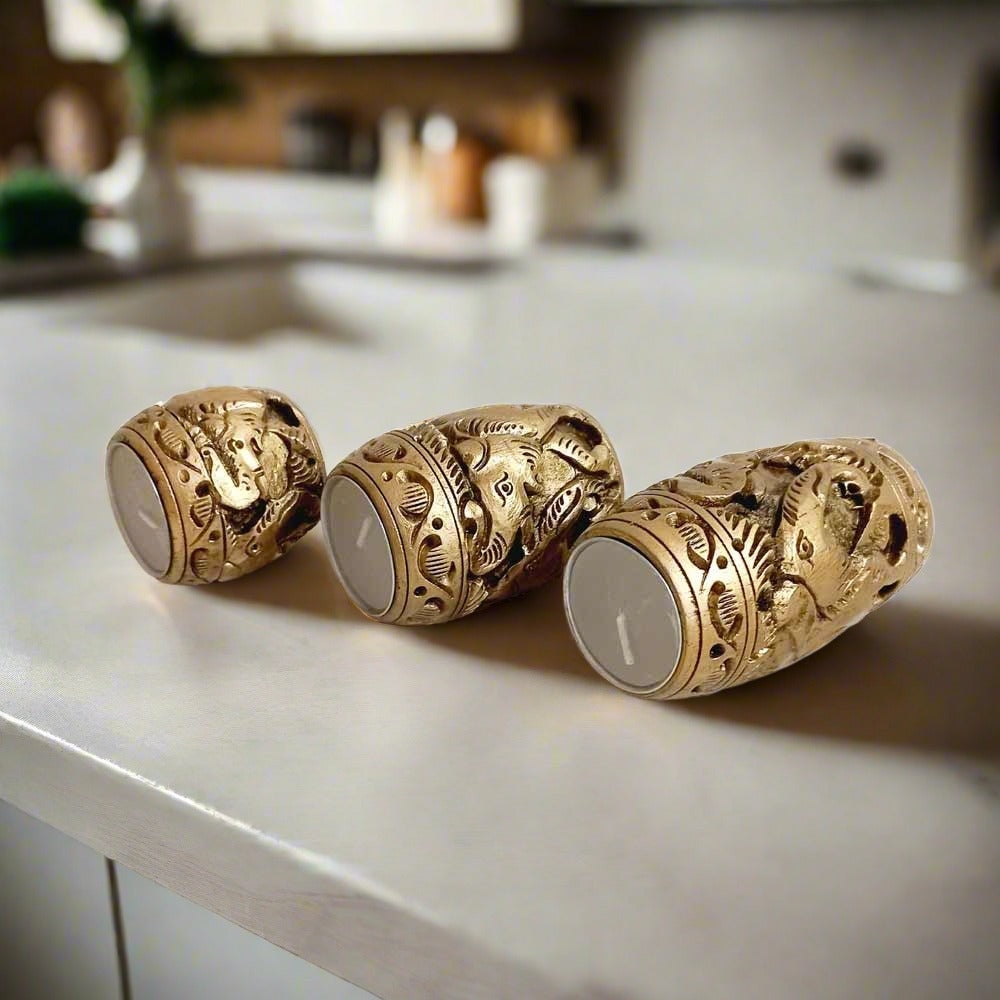 A handcrafted wood carving t-light holder trio, perfect for creating a cozy atmosphere.