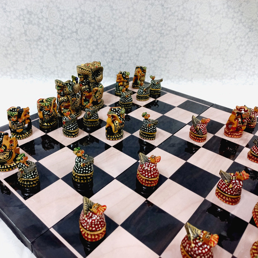 Handcrafted traditional Indian wooden chess set with vibrant red and green colors, perfect for collectors and players.