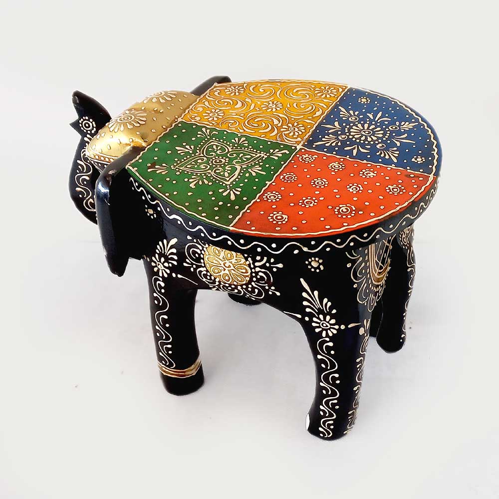 A handcrafted wooden elephant that serves as both a beautiful showpiece and a sturdy stand.