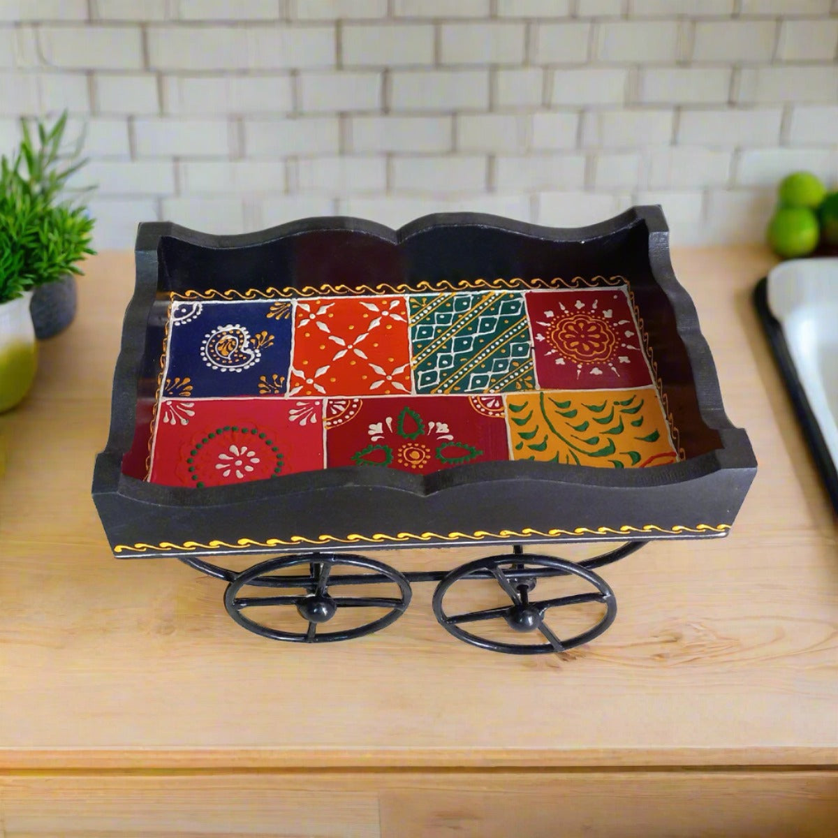 Handcrafted wooden serving tray in cart shape with wheels, decorated with beautiful traditional hand art.