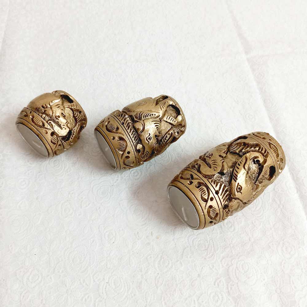 A handcrafted wooden t-light holder set of 3, perfect for creating a warm and cozy ambiance.