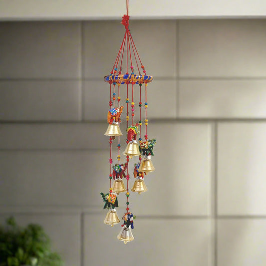 A handmade elephant door hanging with golden bells, a perfect decorative piece for a home or office.