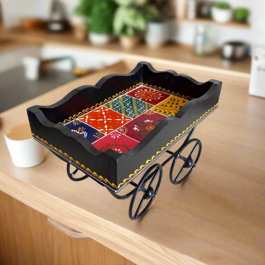 Handmade wooden cart tray featuring traditional designs and hand painting, equipped with wheels for easy movement.