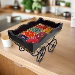Handmade wooden cart tray featuring traditional designs and hand painting, equipped with wheels for easy movement.