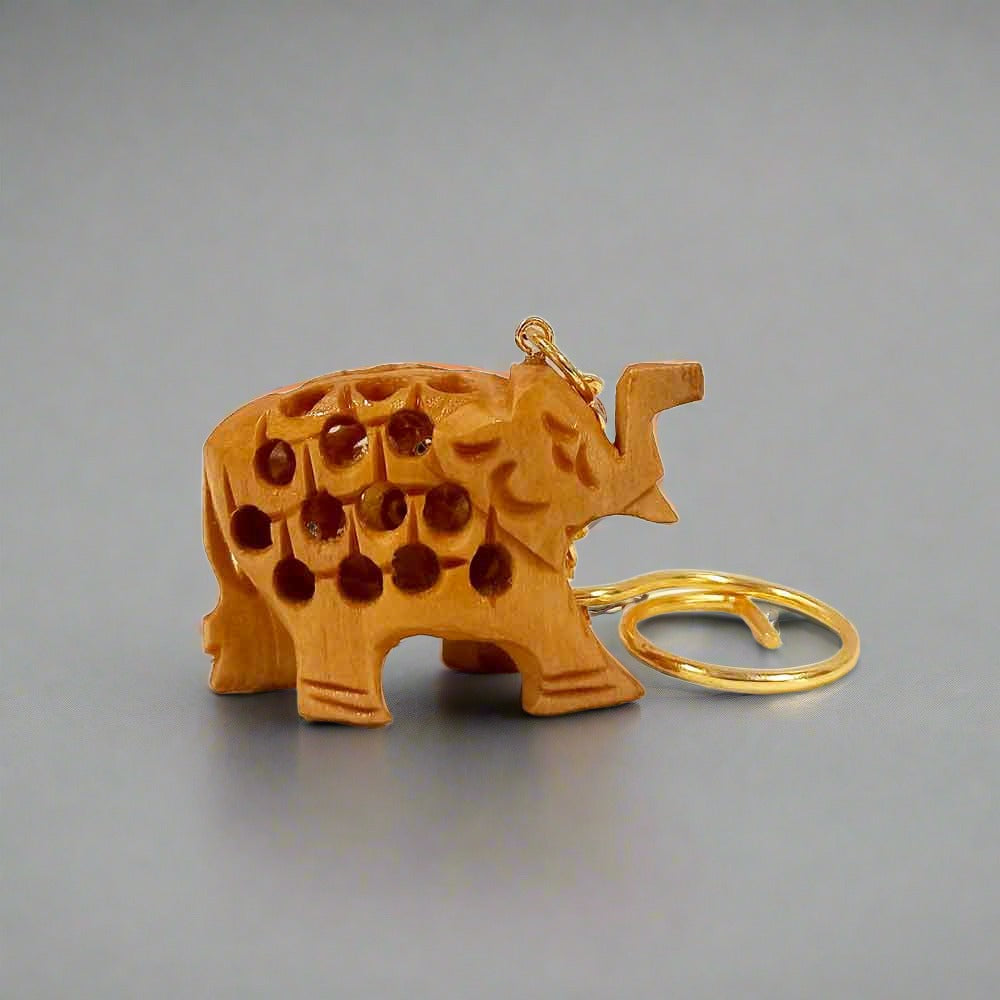 A handmade wooden key chain with an elephant design, perfect for car, bike, and wardrobe keys.