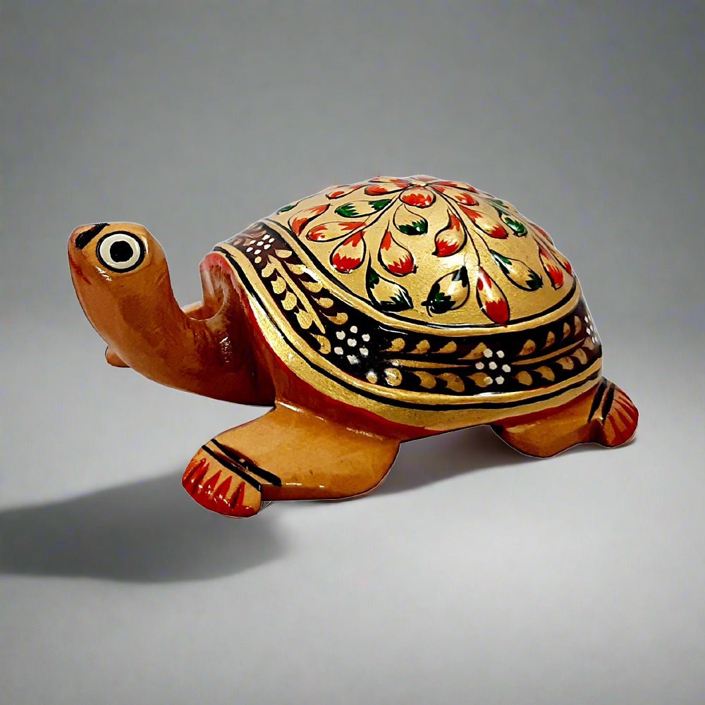 A handmade wooden Vastu tortoise with beautiful golden emboss painting, perfect for home and office.
