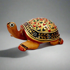 A handmade wooden Vastu tortoise with beautiful golden emboss painting, perfect for home and office.