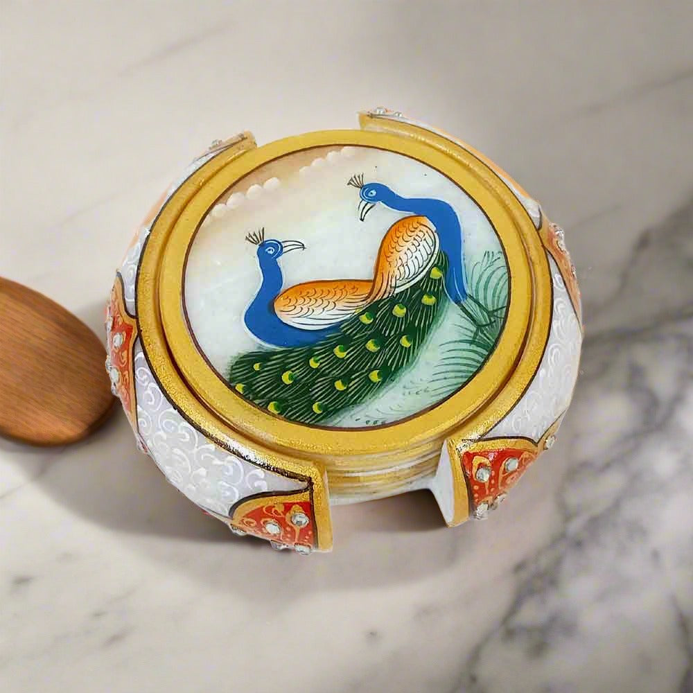 Handmade marble coasters with intricate peacock paintings, round shape, and decorative embossed holder.