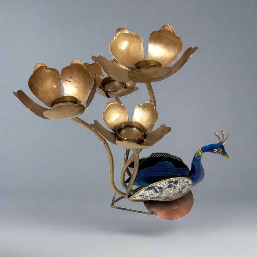 Hand-painted metal peacock showpiece with glass-adorned feathers and four lotus-shaped candle holders, perfect for home or office decor.