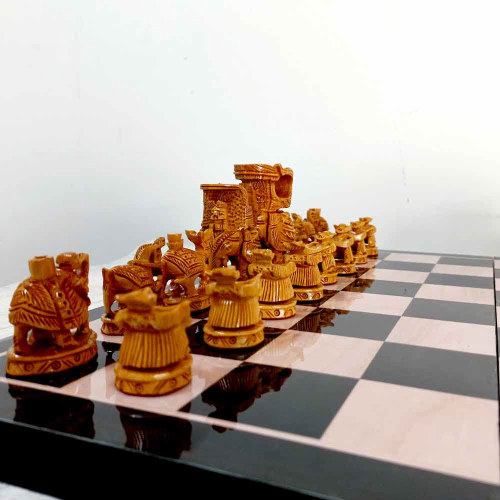An Indian Ambari elephant figurine chess set with a solid wood playing board, a perfect addition to a collector's showcase.