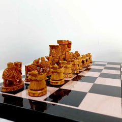 An Indian Ambari elephant figurine chess set with a solid wood playing board, a perfect addition to a collector's showcase.
