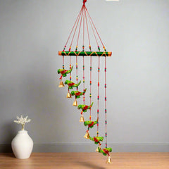 Interior decor papermache parrot toran featuring vivid green parrots and golden bell embellishments, handmade.