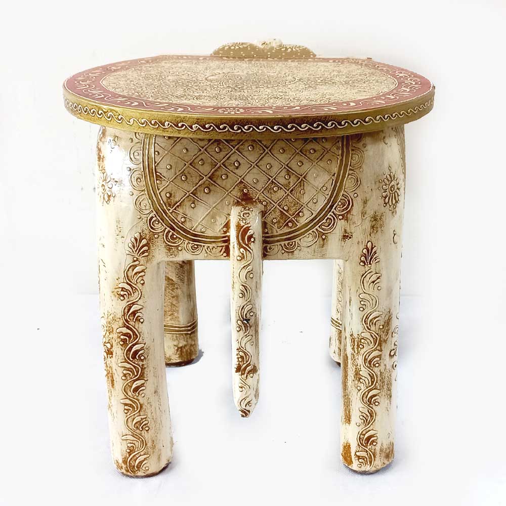 An ivory-painted elephant stool that gives a royal and grand look to any room.