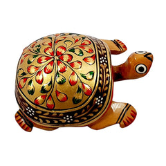 A Kadamb wood Vastu turtle showpiece with handmade emboss painting, considered best for good luck.