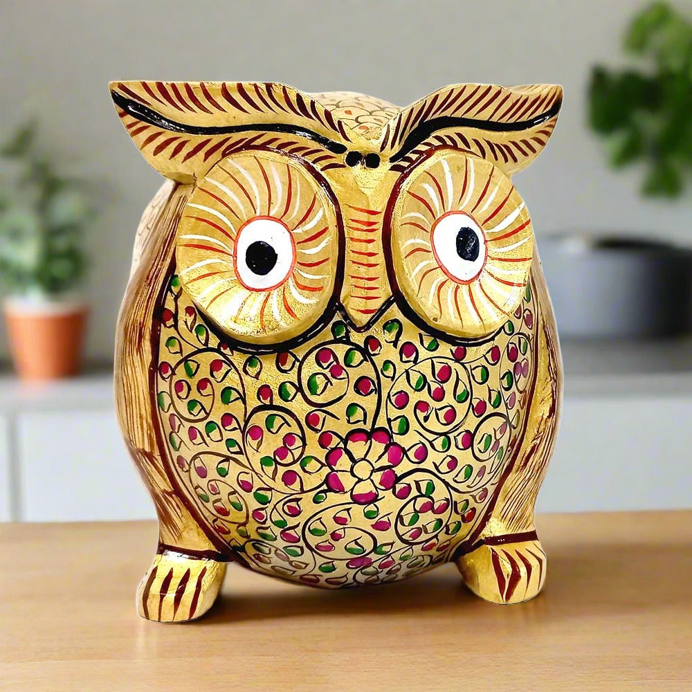 A beautiful hand-painted golden owl figurine made from fine quality Kadamba wood.